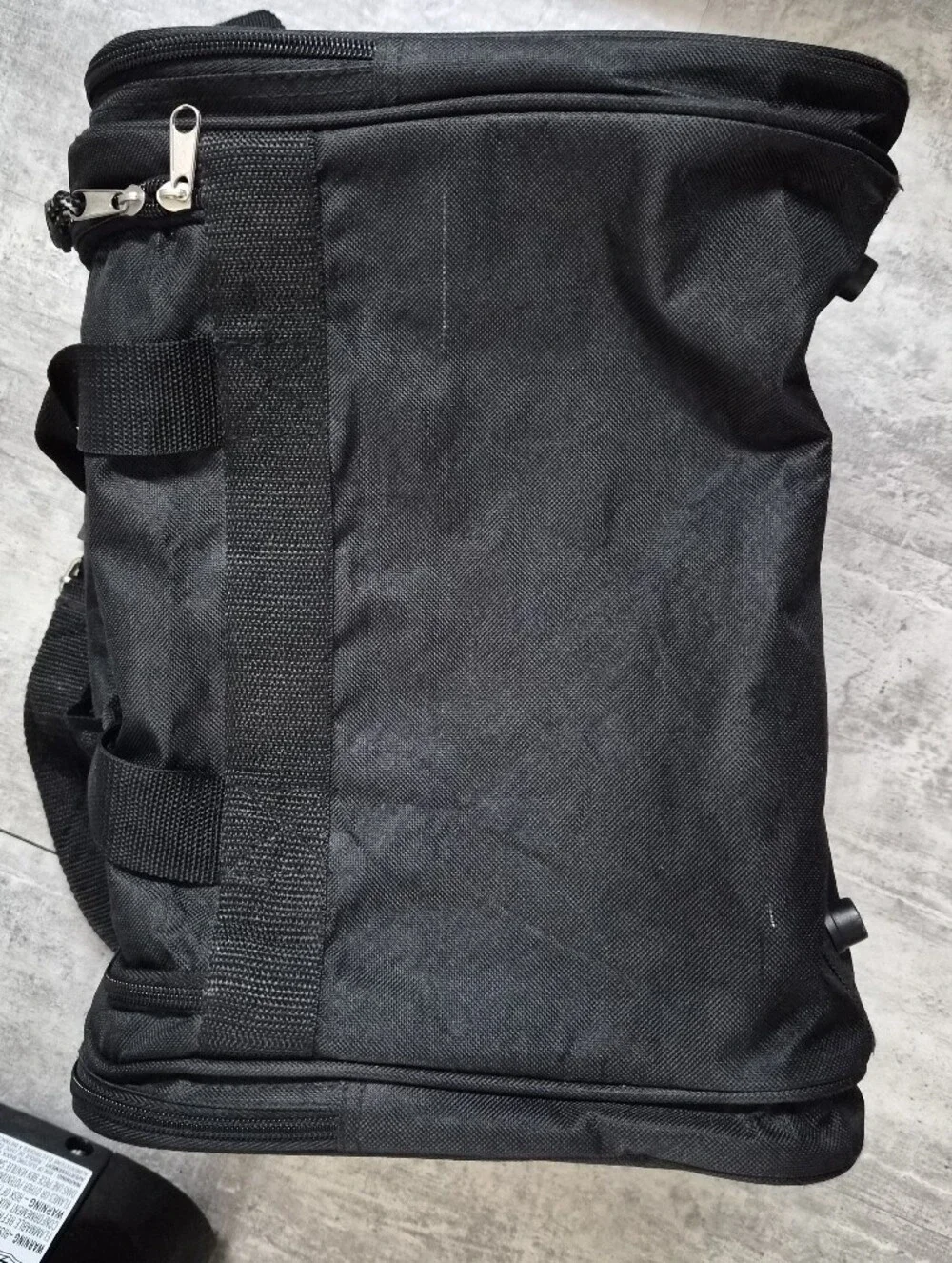 This black Tournamax duffel bag features a prominent logo and secured  pockets